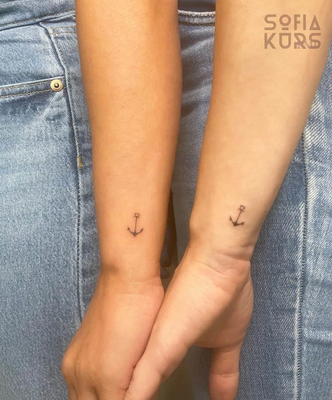 Tiny matching anchor tattoos
