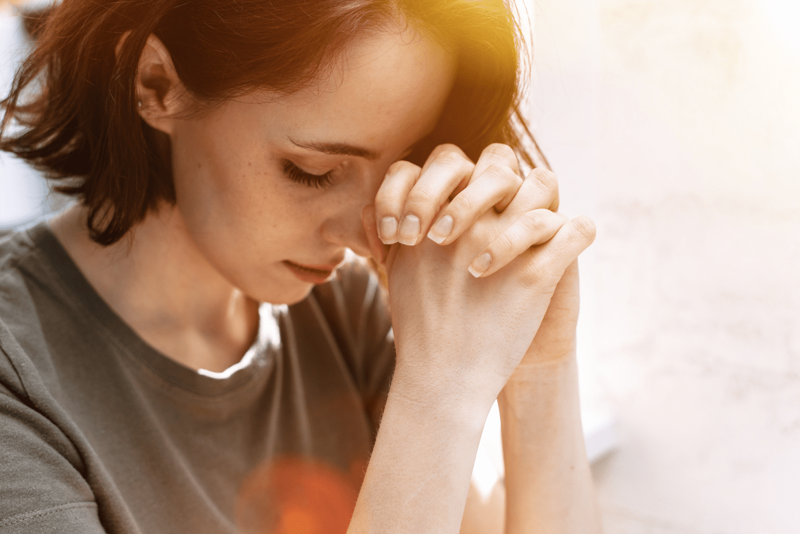 a woman with short hair is praying