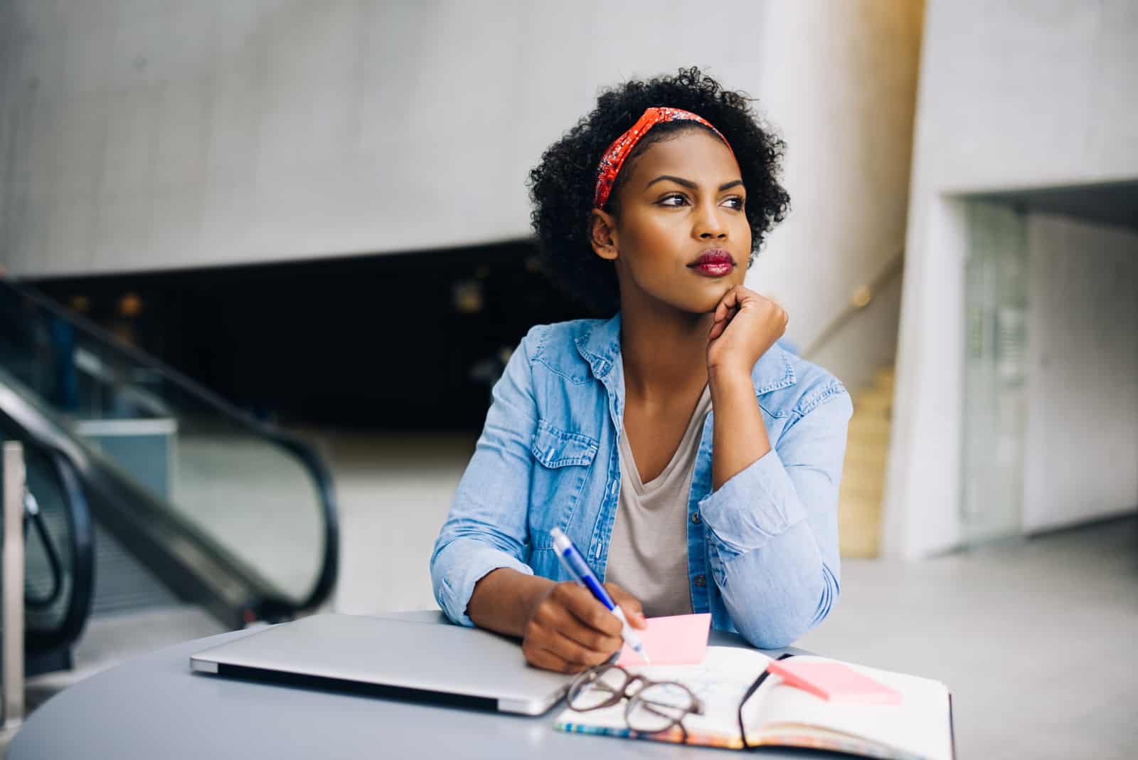 black woman sitting and looking into distance