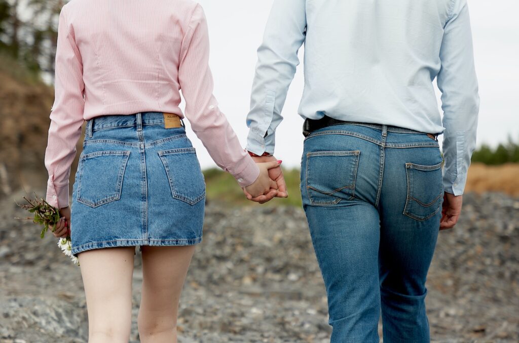 couple holding hands and walking