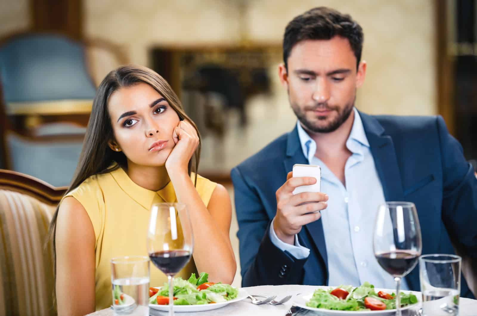 couple on a date ignoring each other