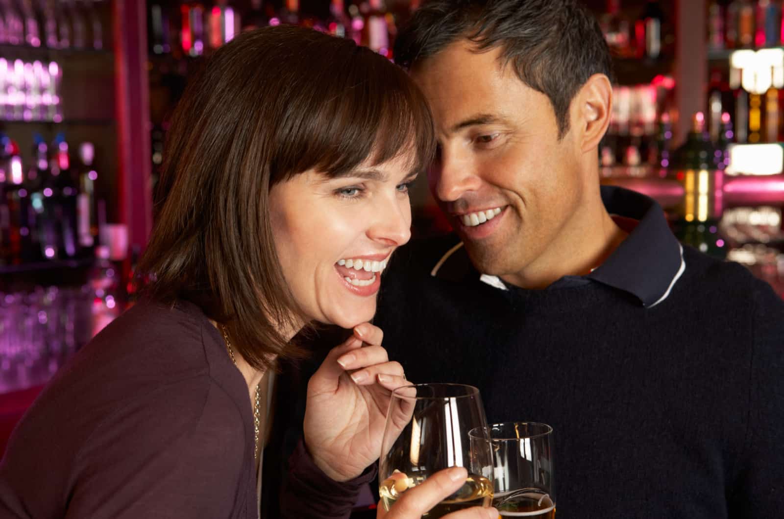 man and woman flirting in bar