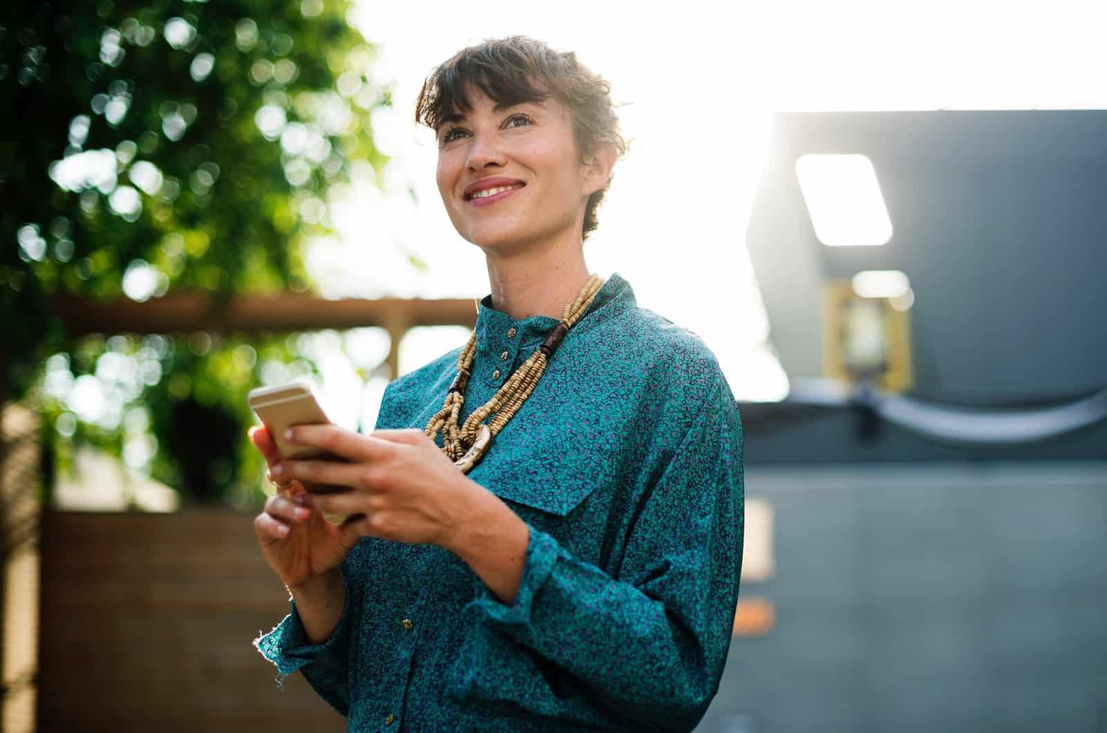 woman thinking of a funny text to send to someone ignoring her