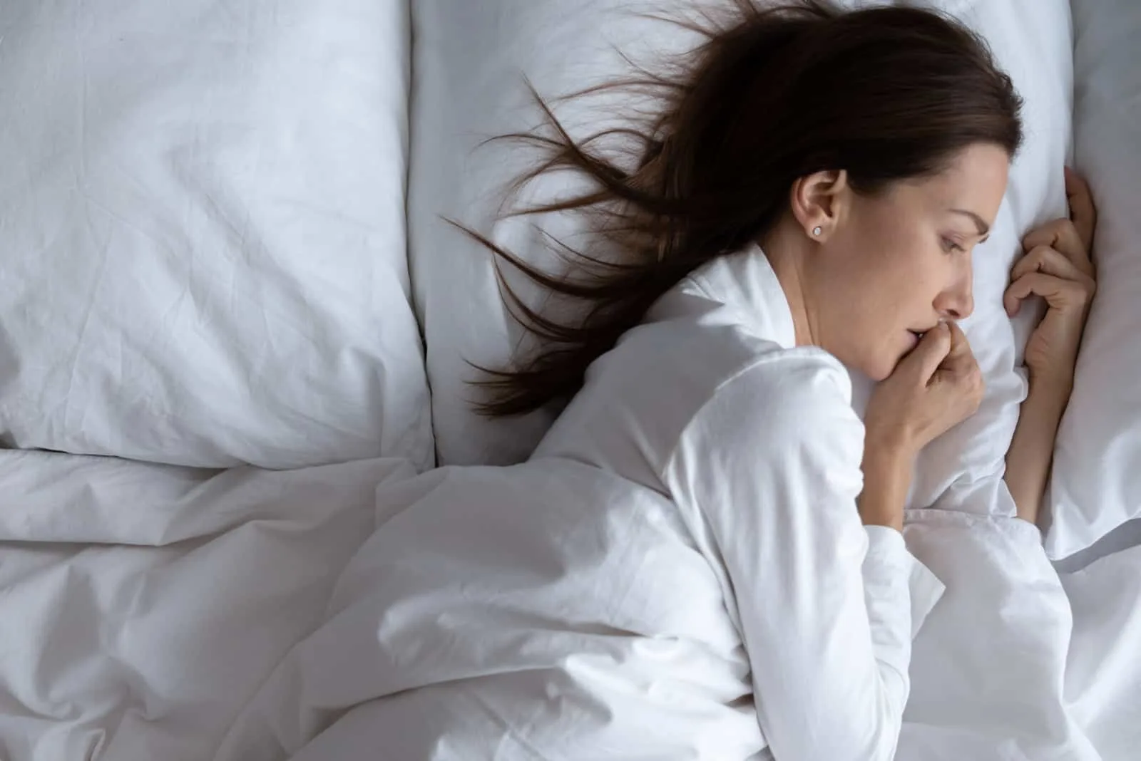worried woman lying in bed