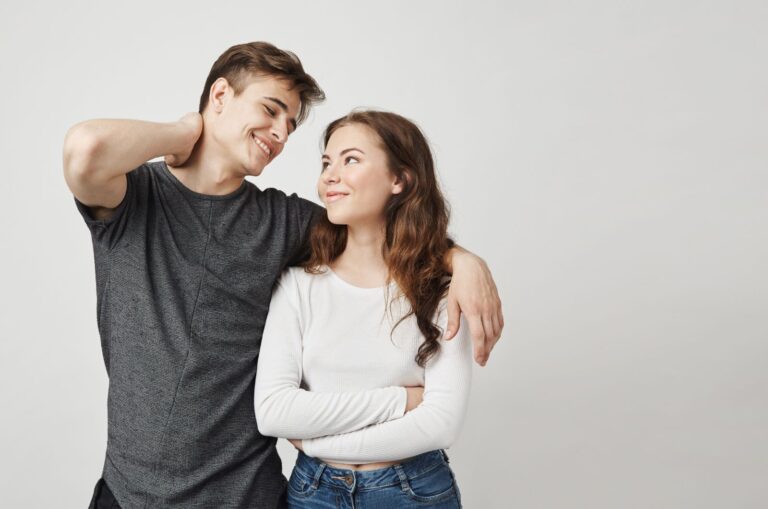 husband and wife hugging, smiling and looking at each other while rethinking divorce