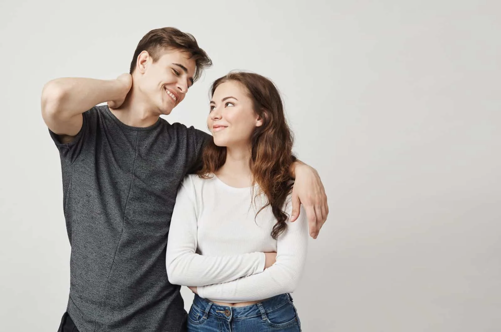 husband and wife hugging, smiling and looking at each other while rethinking divorce