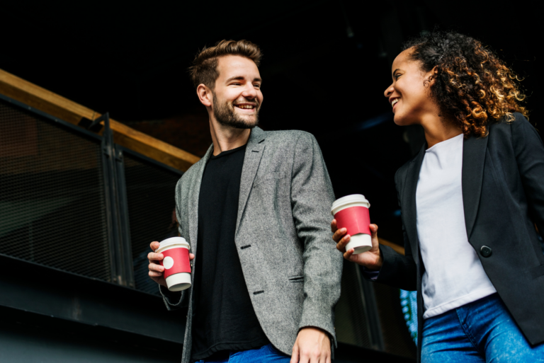 smiling man and woman are walking and talking