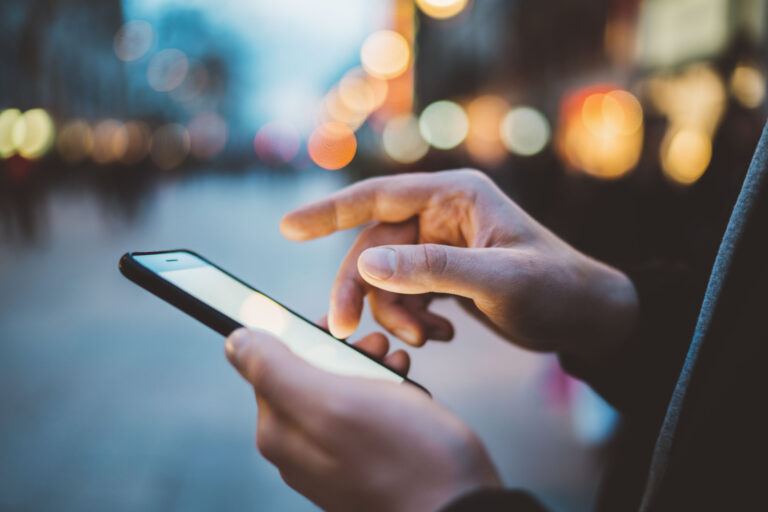 person types on phone