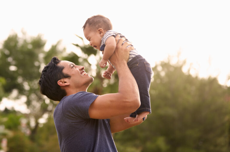 man who wants his wife pregnant playing with a baby