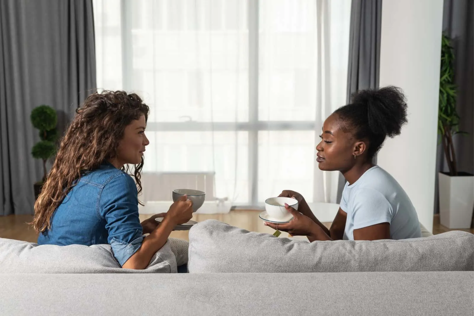 two friends talking on a couch