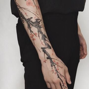 Blossoms on a branch half-sleeve tattoo