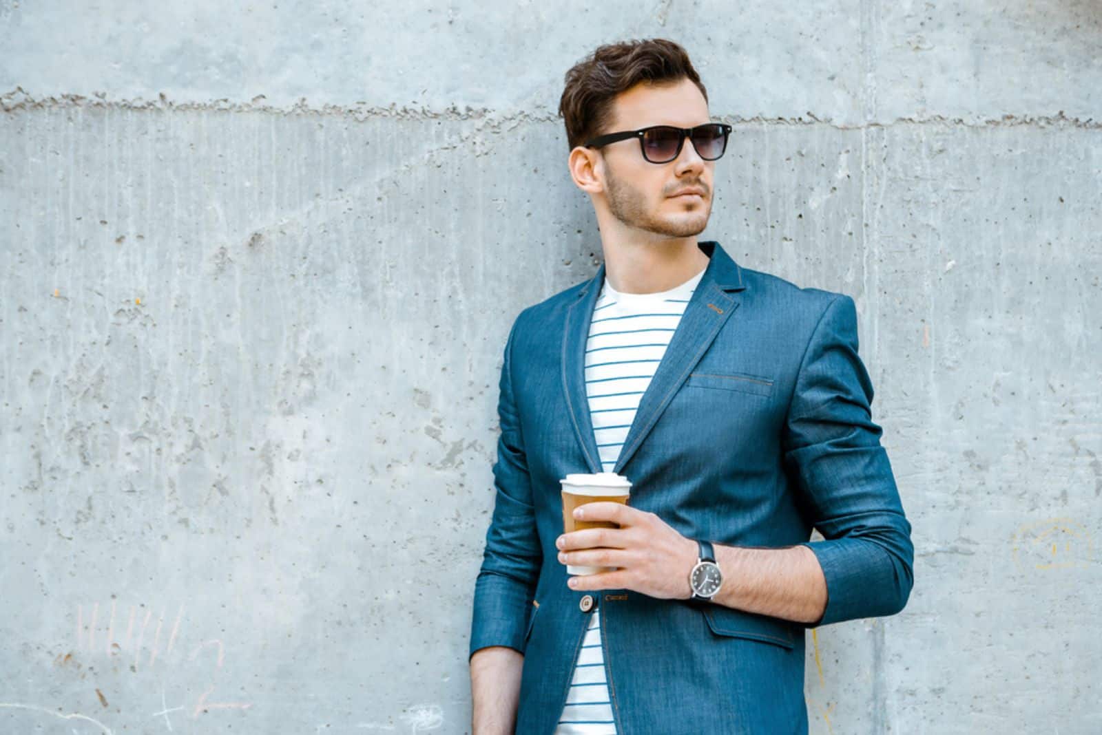 handsome man holding a cup of coffee