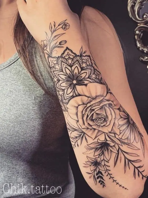 Decorative floral half-sleeve forearm tattoo
