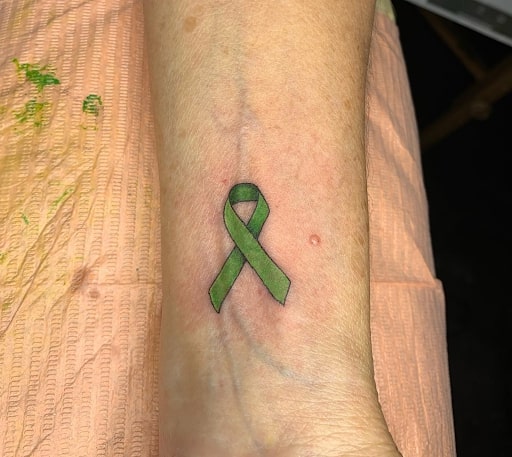 Green ribbon wrist tattoo