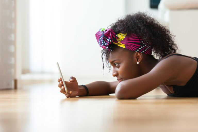 woman sending a text message on a mobile phone