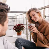 blonde woman smiles at a man
