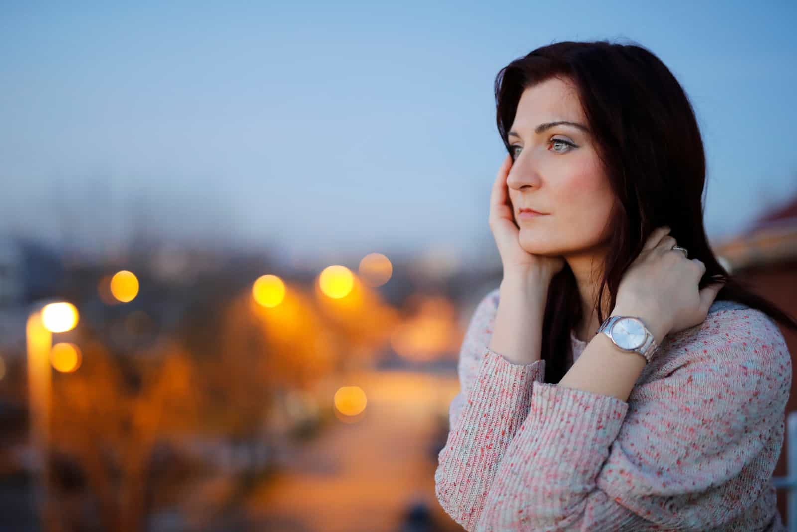 woman sitting outside thinking about her ex