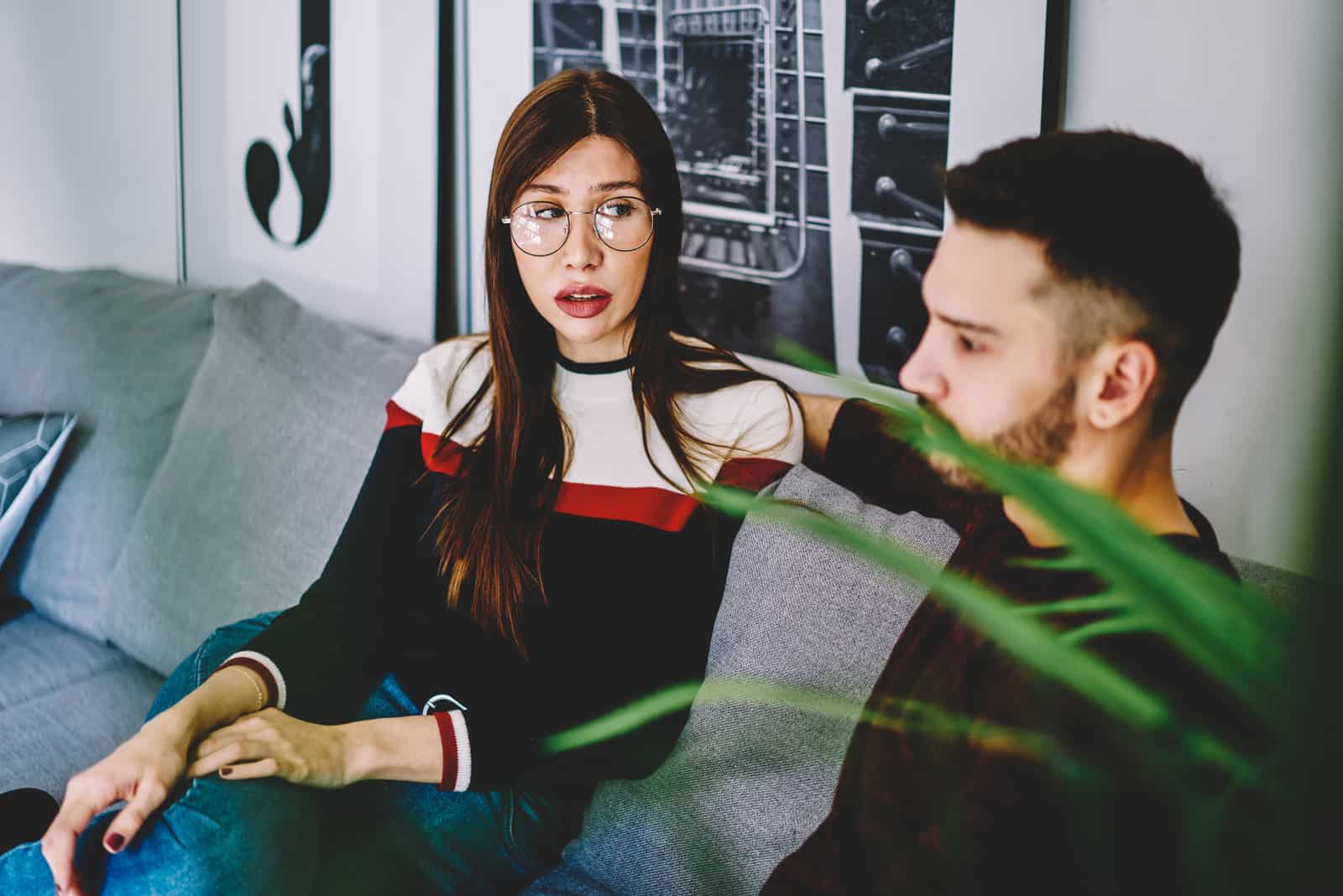 couple sitting on sofa in living room