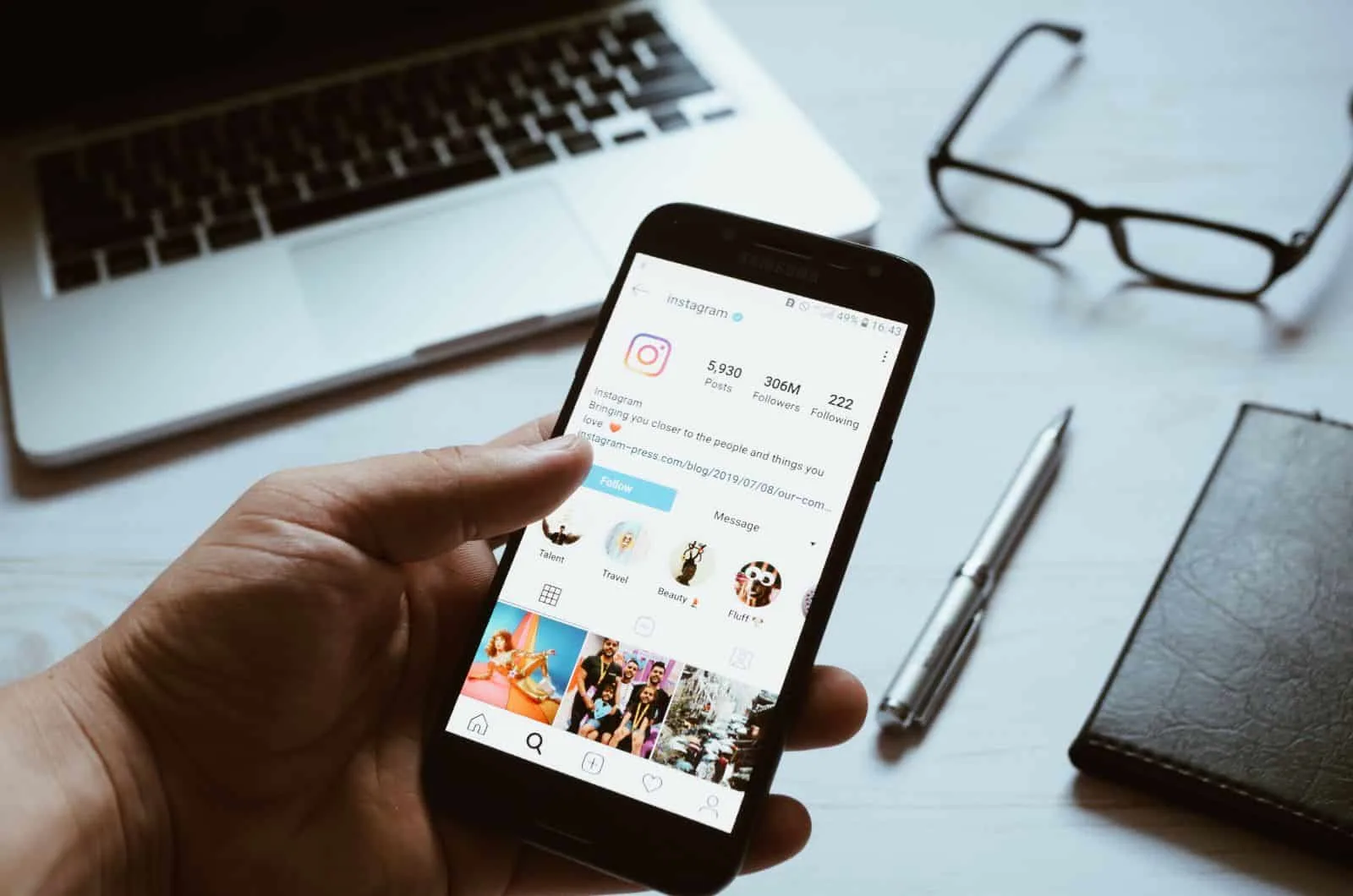 man looking at his instagram profile and holding a smartphone in his hand