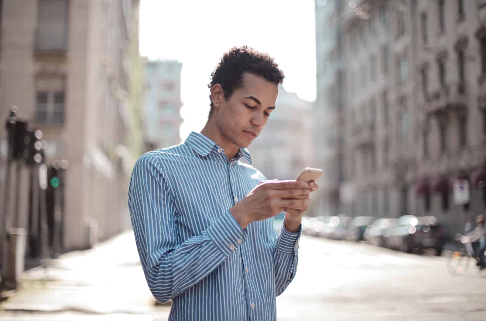 man reading a text from someone disappointed in him