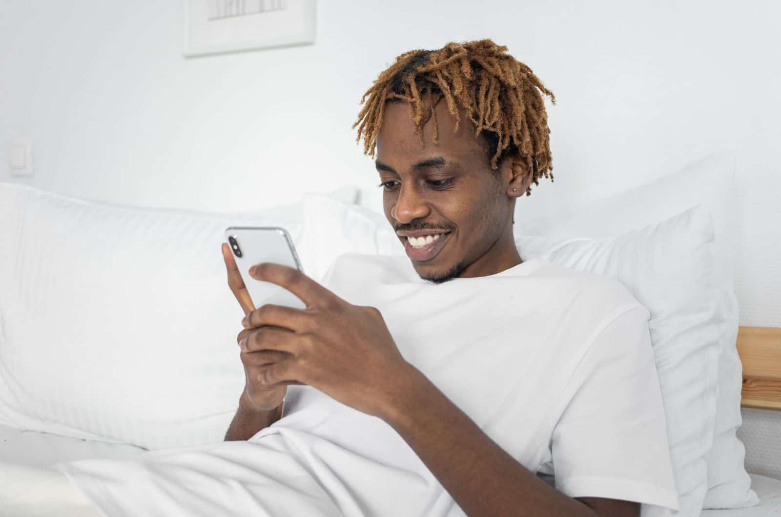 man reading a good morning text and smiling