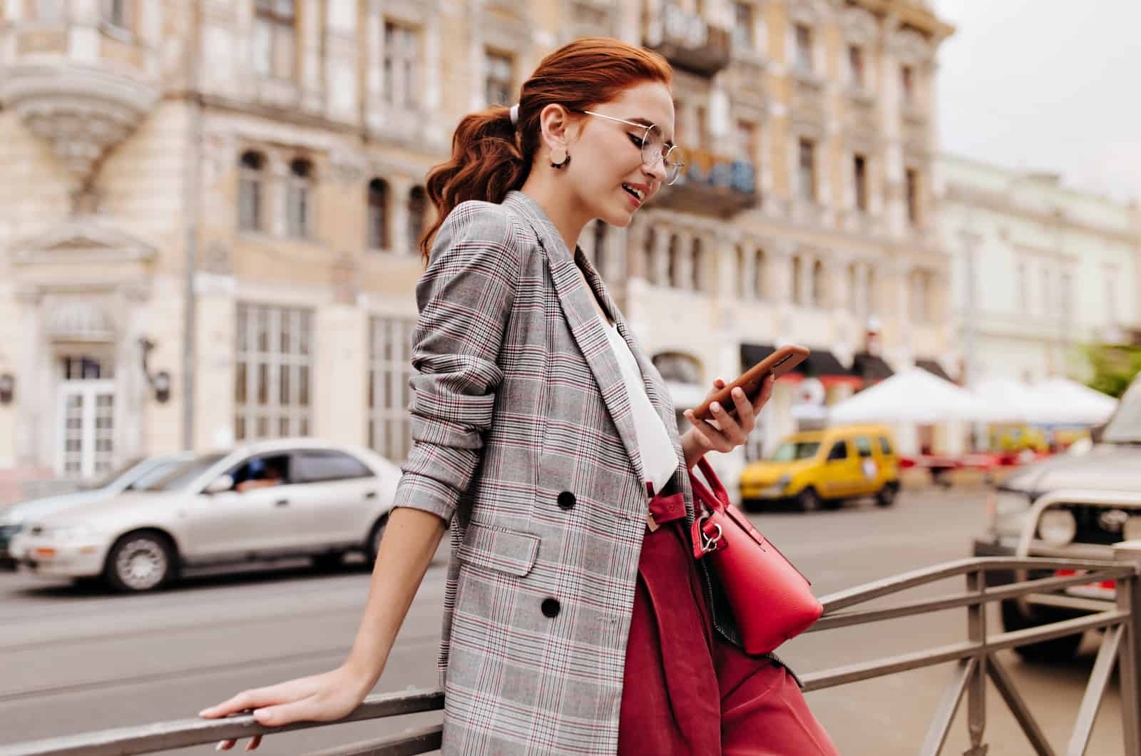 single woman standing on street and chatting on phone