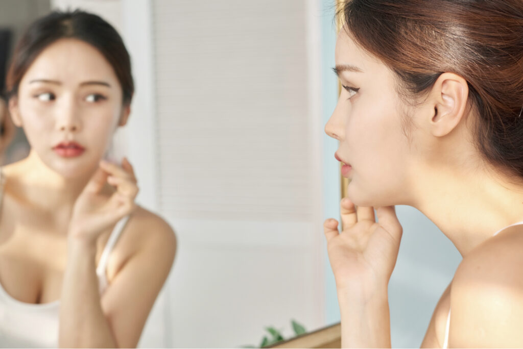 woman checking her reflection in the mirror
