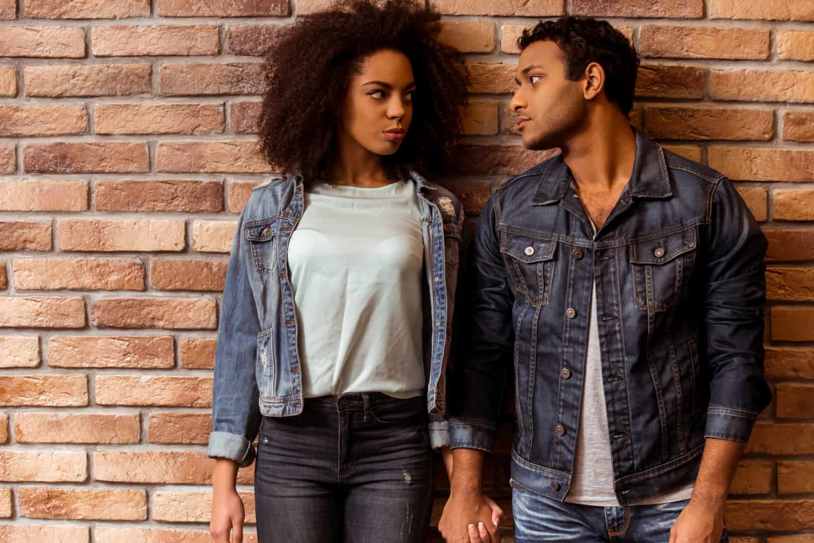 young couple holding hands and looking at each other