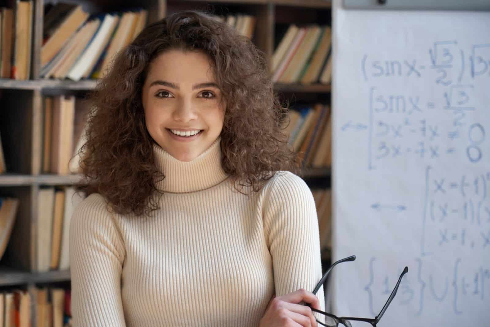 smiling young teacher posing in classroom