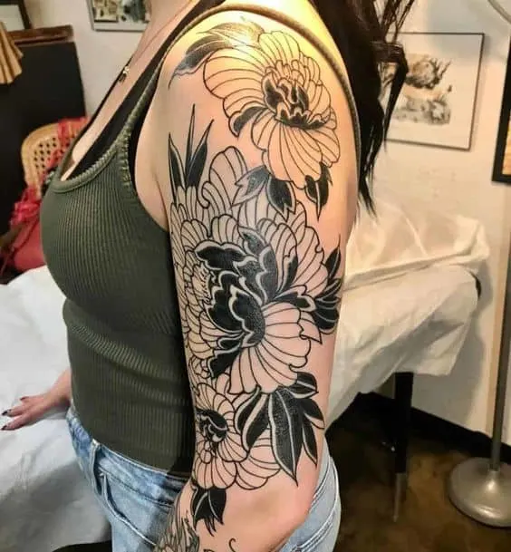 Black and white flowers arm sleeve tattoo