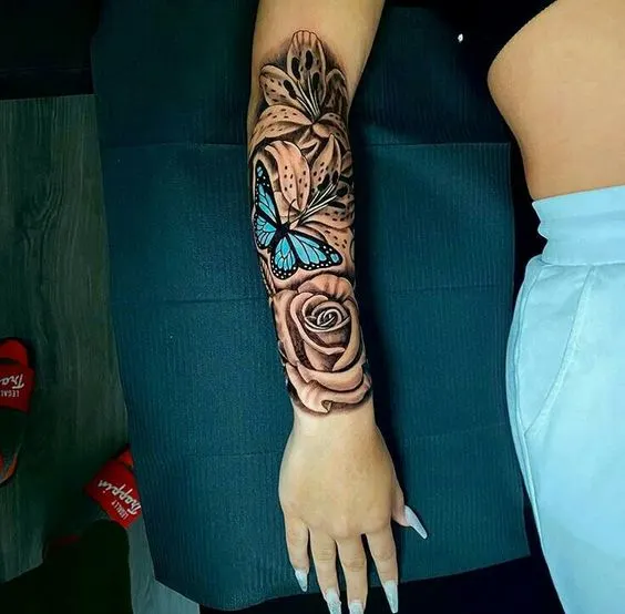 Butterfly and roses forearm half-sleeve tattoo