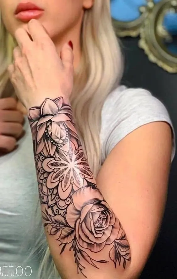 Floral arm sleeve tattoo