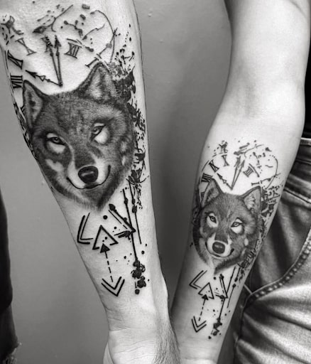 Two wolves and the clock tattoo