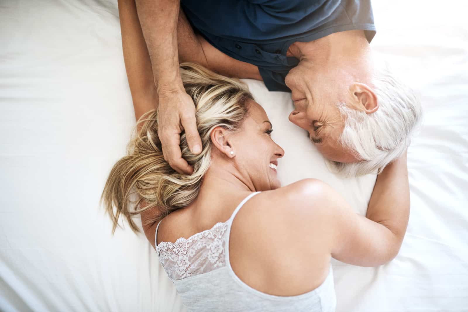 mature couple lying in bed