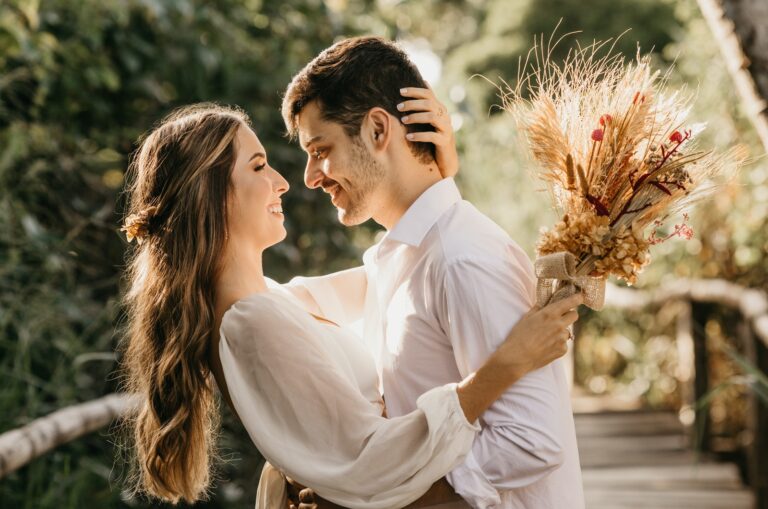 married couple dressed in white hugging