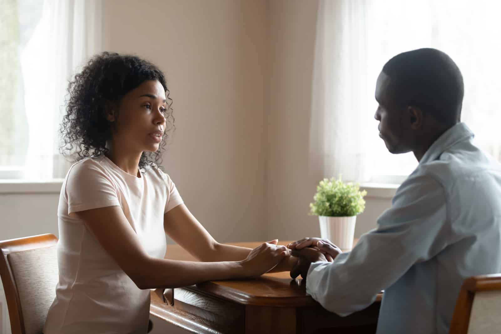 couple talking and holding hands