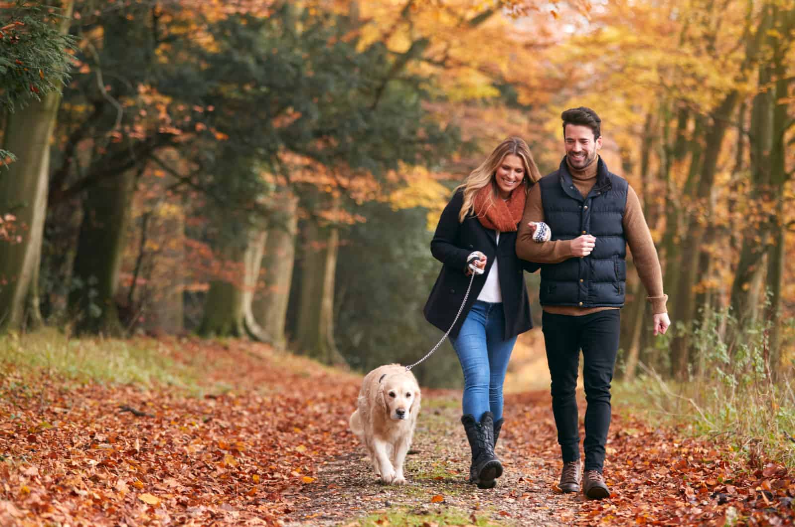 couple walking the dog outside