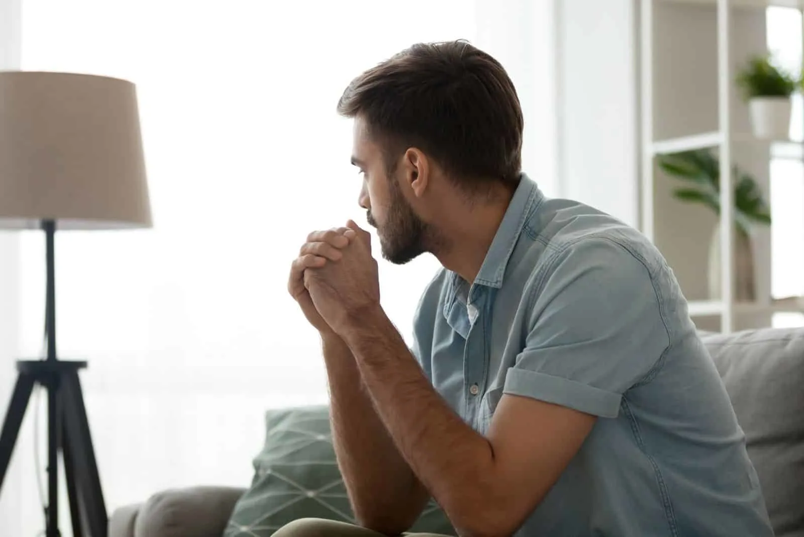 pensive man sitting on the couch