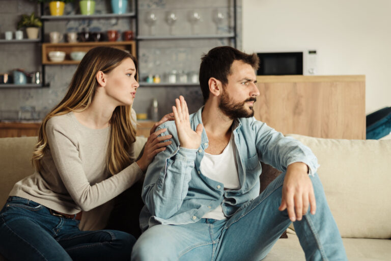 Angry man doesn't pay attention to his girlfriend