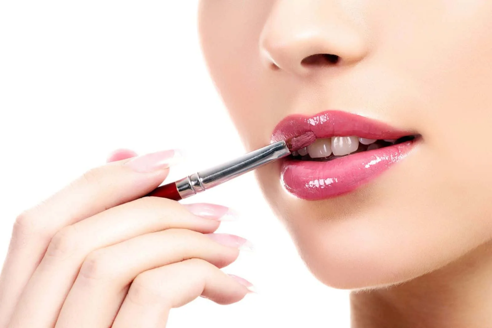 beautiful young woman applying lips makeup