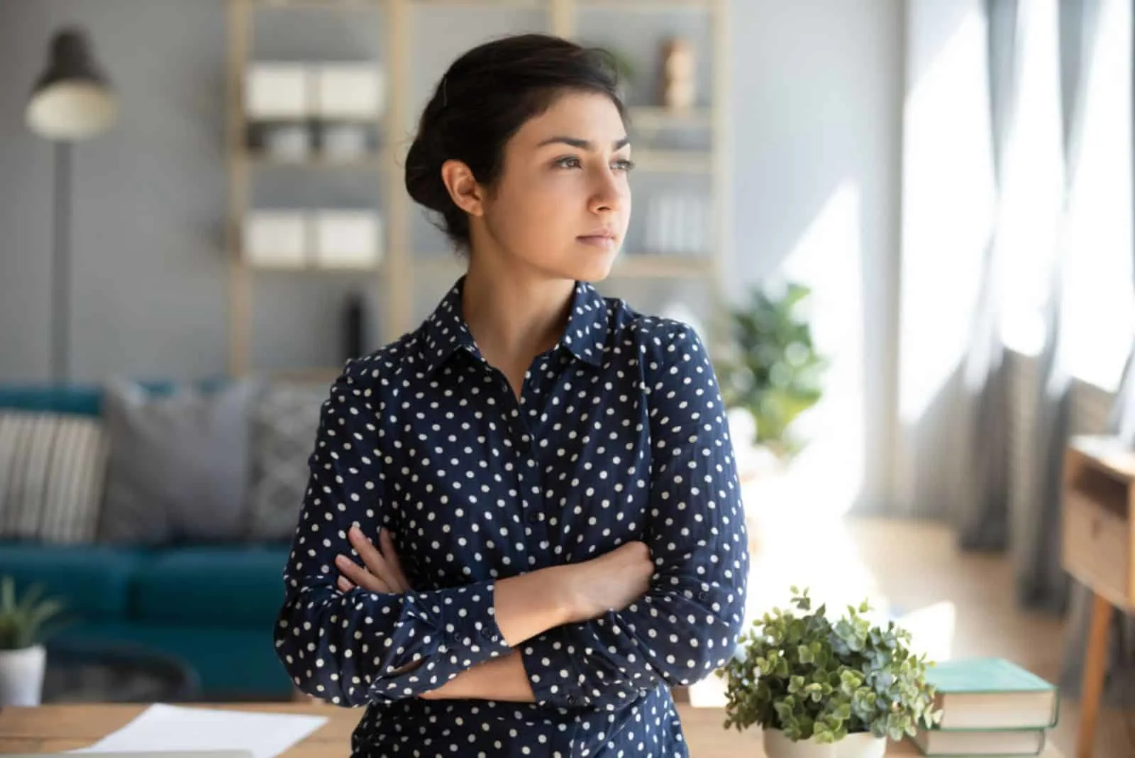 serious woman looking at distance at home