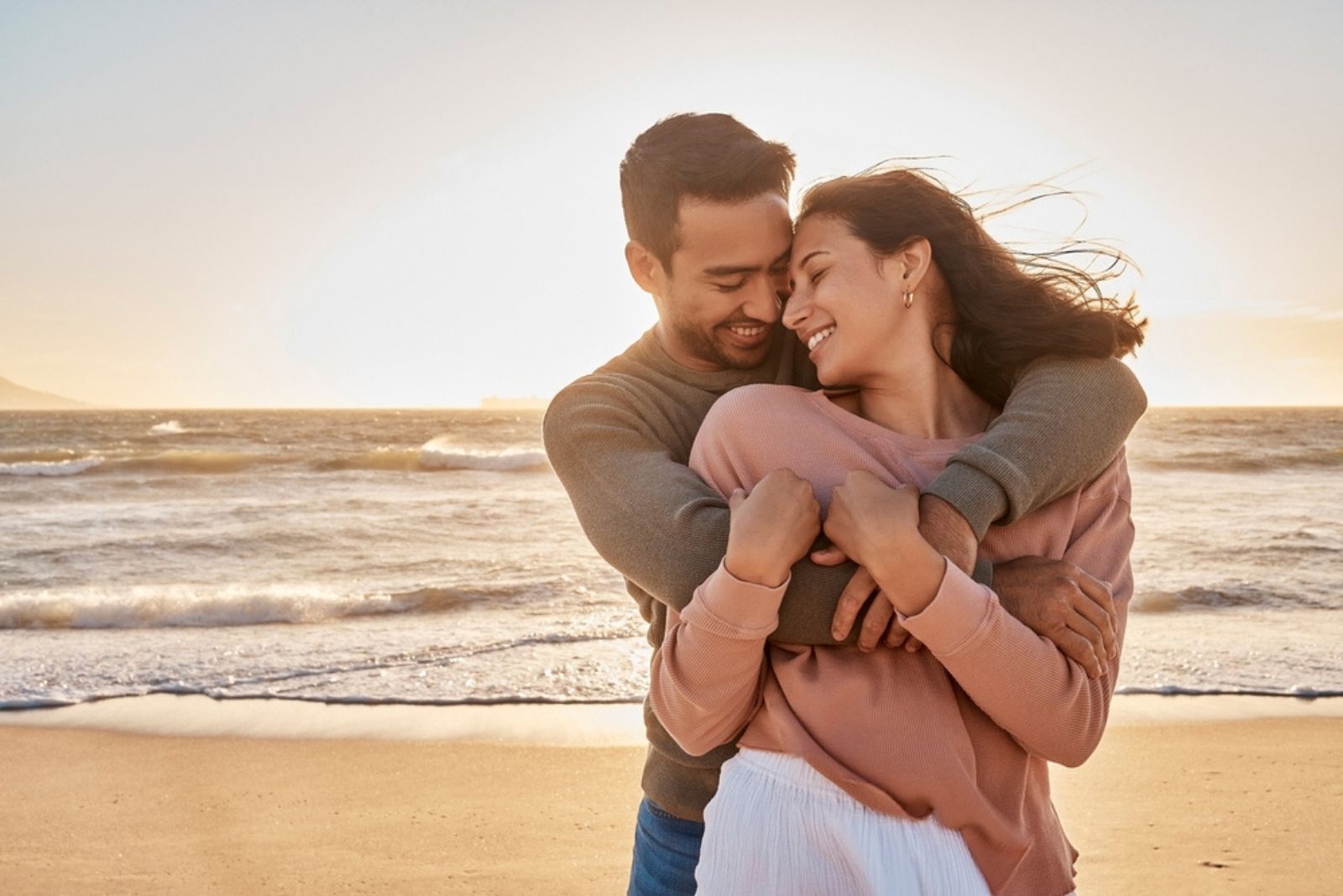 happy couple in hug on the beach