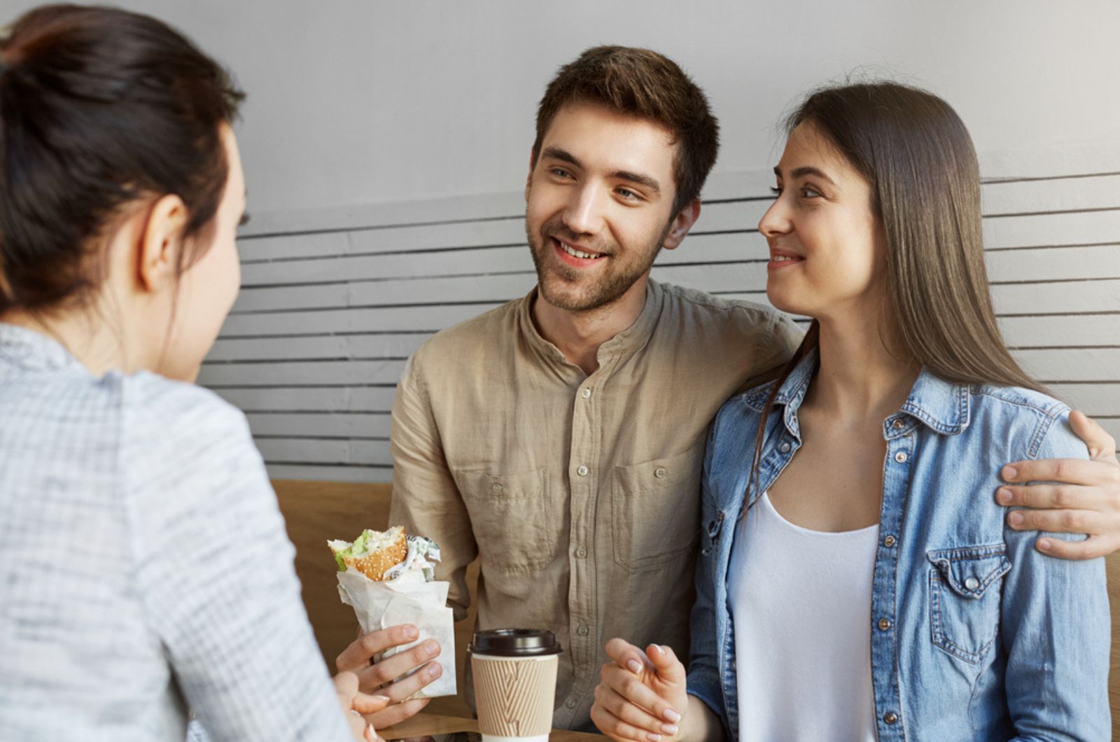 Beautiful man with dark hair in stylish clothes introducing his girlfriend to mother