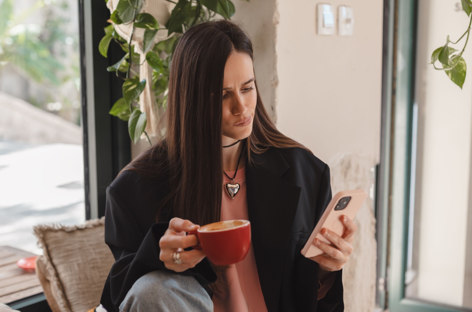 confused woman looking at her phone