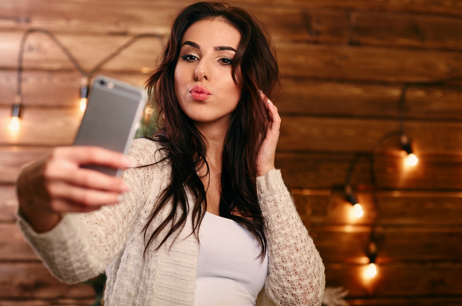 brunette taking a selfie with her phone