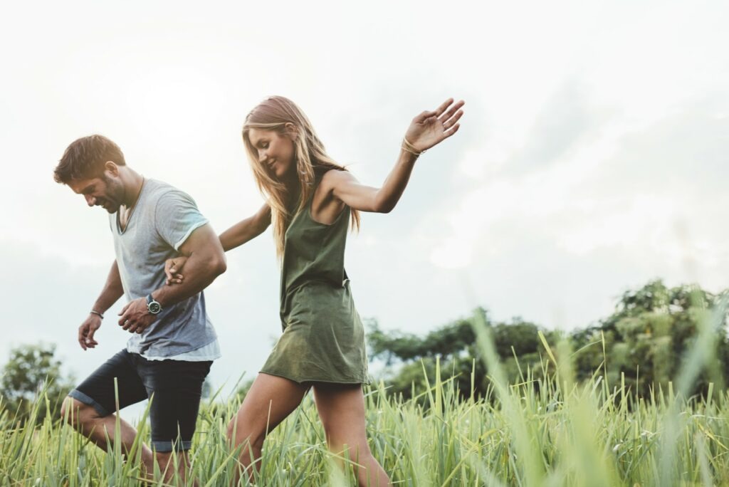 couple walks in the field