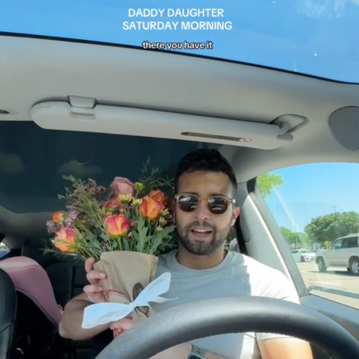 guy with flowers in the car