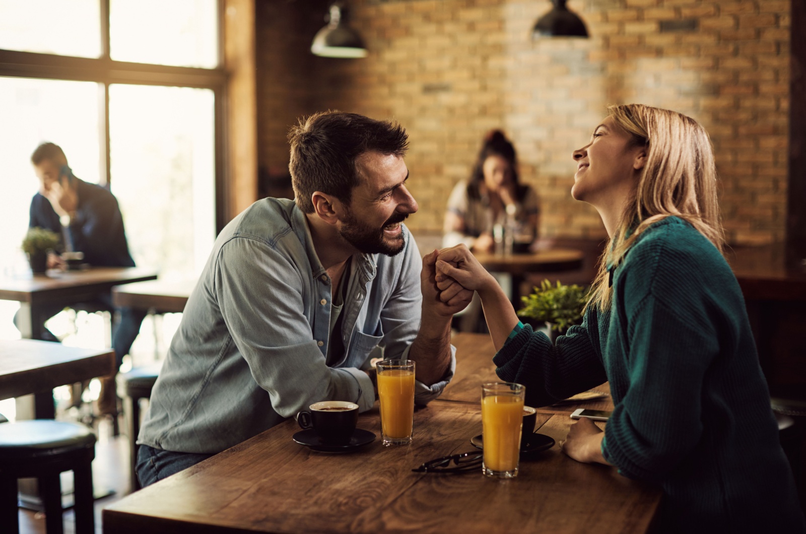 man holding woman's hand while talking