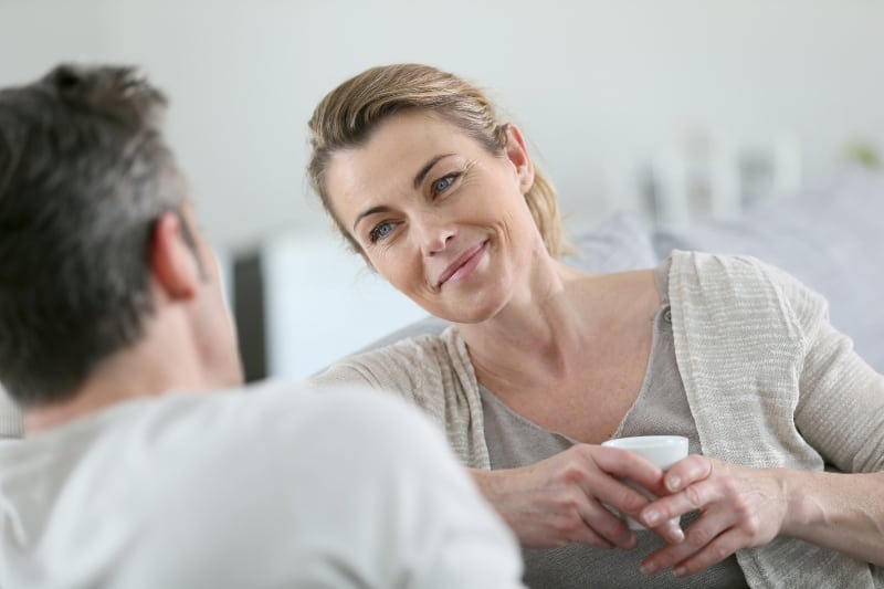 smiling woman listening to man