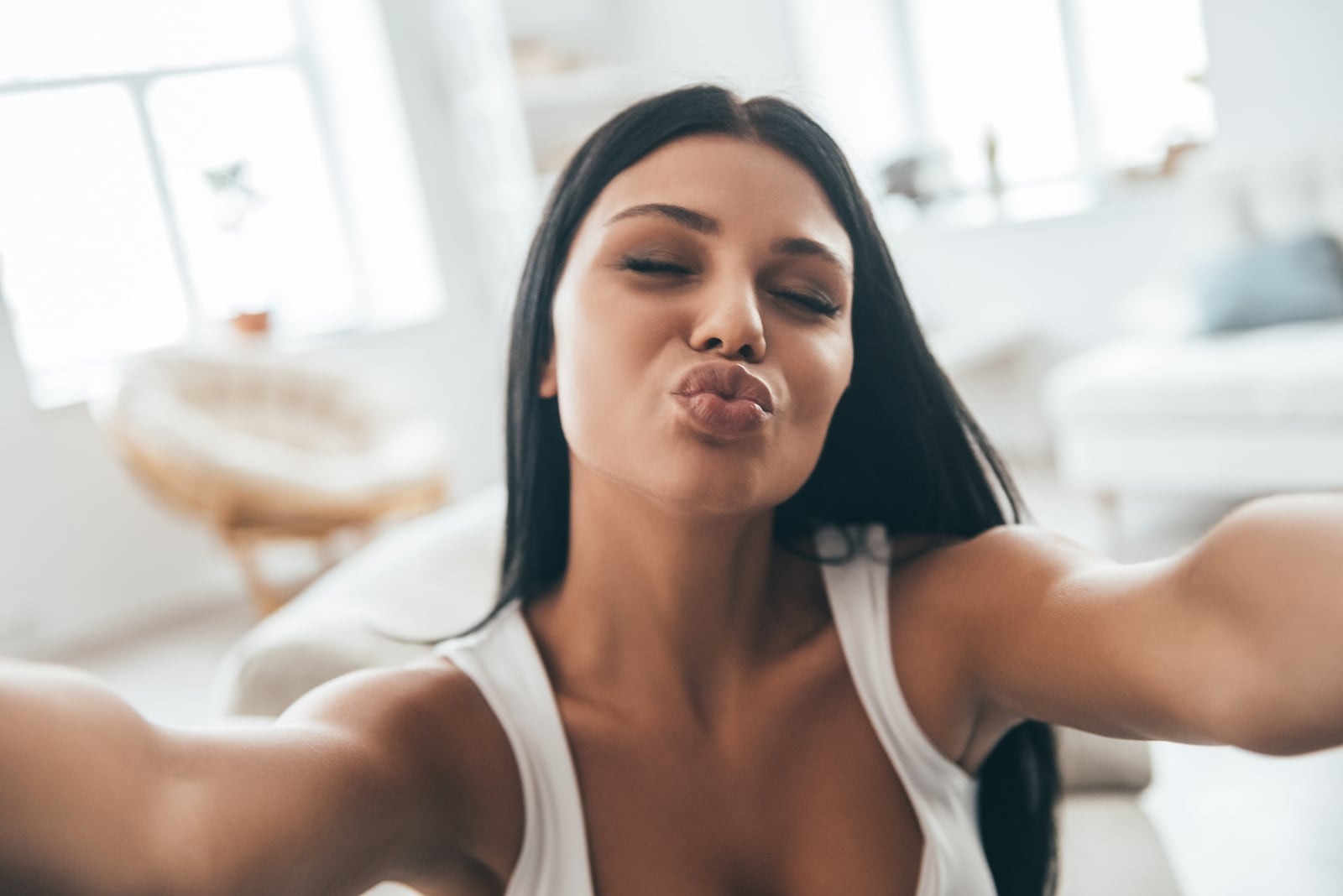 woman taking selfie with duck face